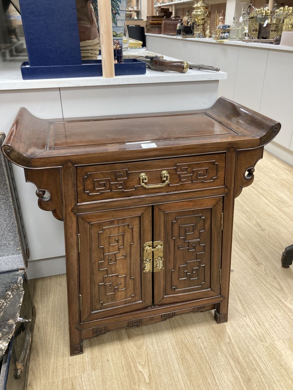 A Chinese carved hardwood side cabinet, fitted one long drawer over a pair of doors, width 70cm depth 38cm height 80cm